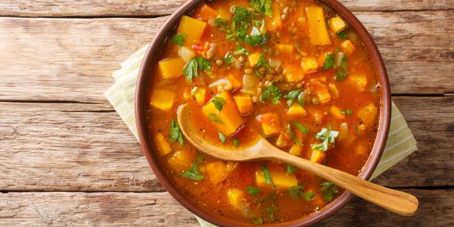 Traditional thick sweet potato soup with lentils close up in a bowl on the table.