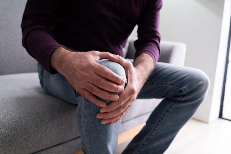 a man holding his knee for support