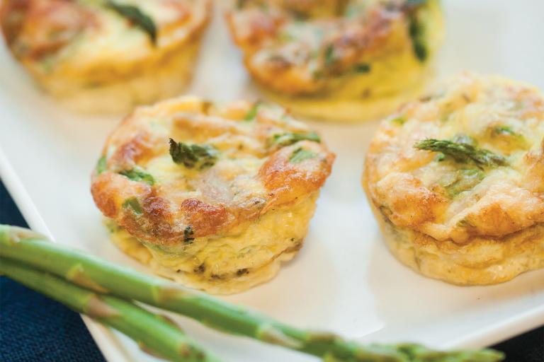 A plate of home-made mini-frittatas with asparagus, spinach, and chicken sausage